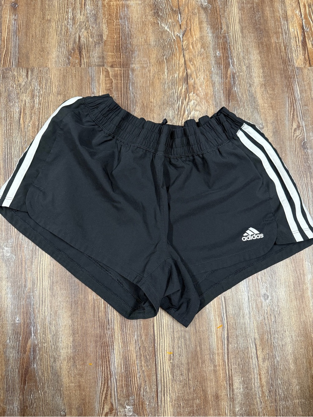 Adidas black shorts with white stripes, size M